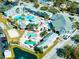 Aerial view of resort with swimming pools, ponds, tennis courts, parking, and landscaping at 1849 Abrico Dr # 4, Lutz, FL 33558