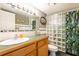 Bathroom features a green solid surface countertop, updated fixtures and glass block at 1849 Abrico Dr # 4, Lutz, FL 33558