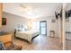 Airy bedroom features tiled floors, ceiling fan, slider to patio and closet at 1849 Abrico Dr # 4, Lutz, FL 33558
