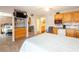 Cozy bedroom features kitchenette, tiled floors, ceiling fan and view into adjacent bathroom at 1849 Abrico Dr # 4, Lutz, FL 33558