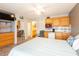 Cozy bedroom features kitchenette, tiled floors, ceiling fan and view into adjacent bathroom at 1849 Abrico Dr # 4, Lutz, FL 33558