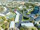 A high-angle shot displays a well-maintained condo complex, complete with tennis courts, parking, and a tranquil pond at 1849 Abrico Dr # 4, Lutz, FL 33558