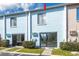 Exterior of the condo showing sliding glass doors and a small patio with green bushes at 1849 Abrico Dr # 4, Lutz, FL 33558