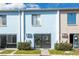 Exterior view featuring sliding glass doors, tidy landscaping, and a well-kept facade at 1849 Abrico Dr # 4, Lutz, FL 33558