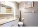Half bath features a white vanity with a granite countertop at 1849 Abrico Dr # 4, Lutz, FL 33558