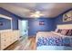 Comfortable bedroom features plank flooring, a ceiling fan, and a white dresser at 1849 Abrico Dr # 4, Lutz, FL 33558