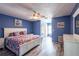 Spacious bedroom with a ceiling fan and a white bed frame with a colorful comforter at 1849 Abrico Dr # 4, Lutz, FL 33558