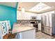 Well-lit kitchen featuring stainless steel appliances, granite countertops, and mosaic backsplash at 1849 Abrico Dr # 4, Lutz, FL 33558