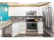 Well-equipped kitchen with granite countertops, stainless steel appliances, and modern white cabinetry at 1849 Abrico Dr # 4, Lutz, FL 33558