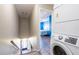 A laundry area next to the staircase and a bedroom showcases the practicality of the home's layout at 1849 Abrico Dr # 4, Lutz, FL 33558