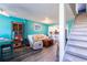 A well-lit living room with stairs, a sofa, and open access to the bright kitchen area at 1849 Abrico Dr # 4, Lutz, FL 33558