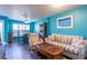 Comfortable living room with a dining area, a striped sofa, and beach-themed decor on the walls at 1849 Abrico Dr # 4, Lutz, FL 33558
