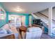 The open-concept living space shows seating, television, stairs and an eat-in kitchen at 1849 Abrico Dr # 4, Lutz, FL 33558