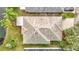 Aerial view of a well-maintained roof and surrounding lush greenery of the property at 29523 Waggle Dr, San Antonio, FL 33576