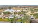 An aerial view shows the lake, pond, trees, and houses at 29523 Waggle Dr, San Antonio, FL 33576