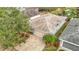 A charming home featuring a brick driveway, tropical landscaping, and proximity to a tranquil pond at 29523 Waggle Dr, San Antonio, FL 33576