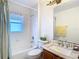 An all-white bathroom features a bathtub, toilet, and vanity with a sink at 29523 Waggle Dr, San Antonio, FL 33576