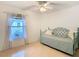 A cozy bedroom features a twin bed, window, and a ceiling fan at 29523 Waggle Dr, San Antonio, FL 33576