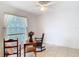 Cozy bedroom featuring tile flooring and a ceiling fan for optimal comfort at 29523 Waggle Dr, San Antonio, FL 33576