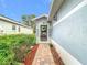 Charming entrance featuring a decorative wreath and well-maintained landscaping at 29523 Waggle Dr, San Antonio, FL 33576