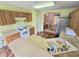 Efficient kitchen with tiled floors, wood cabinetry, and a view into the dining area at 29523 Waggle Dr, San Antonio, FL 33576