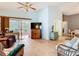 Cozy living room with tiled floors, neutral walls, and sliding glass doors to the backyard at 29523 Waggle Dr, San Antonio, FL 33576