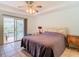 Spacious main bedroom with sliding glass doors to a patio, ceiling fan, and tile flooring at 29523 Waggle Dr, San Antonio, FL 33576