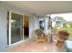 Covered patio featuring wicker seating and sliding glass doors to the home's interior at 29523 Waggle Dr, San Antonio, FL 33576
