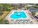 Aerial view of the large community pool and hot tub area with plenty of seating and surrounding lush landscapes and nature areas at 29523 Waggle Dr, San Antonio, FL 33576