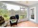 A screened-in porch offers seating, BBQ and views of the backyard pond at 29523 Waggle Dr, San Antonio, FL 33576