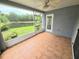 A screened-in porch has tile floors, great views and offers access to the backyard at 29523 Waggle Dr, San Antonio, FL 33576
