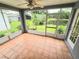 A screened-in porch has tile floors, great views and offers access to the backyard at 29523 Waggle Dr, San Antonio, FL 33576