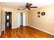 Bedroom with wood floors, ceiling fan, closet, and decorations at 3673 Kings Rd # 102, Palm Harbor, FL 34685