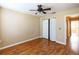 An inviting bedroom featuring hardwood floors, neutral walls, a double door closet and ample natural light at 3673 Kings Rd # 102, Palm Harbor, FL 34685