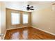 Bright bedroom featuring hardwood floors and a ceiling fan at 3673 Kings Rd # 102, Palm Harbor, FL 34685