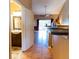 A glimpse into a home featuring tile floors, neutral walls and an open layout to the living room and bathroom at 3673 Kings Rd # 102, Palm Harbor, FL 34685