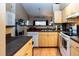 Functional kitchen features tile floors, practical appliances, and an open layout connecting to living spaces at 3673 Kings Rd # 102, Palm Harbor, FL 34685