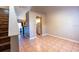 Living room with tile floors, a view of the kitchen, and a staircase at 3673 Kings Rd # 102, Palm Harbor, FL 34685