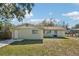 A backyard featuring a grassy lawn and partial view of home's exterior at 4101 W Leila Ave, Tampa, FL 33616