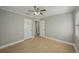 Bedroom featuring neutral walls, tile floors, ceiling fan, and two closets at 4101 W Leila Ave, Tampa, FL 33616