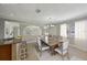 Bright dining room featuring a wooden table, chandelier, and neutral color palette creating an inviting atmosphere at 4101 W Leila Ave, Tampa, FL 33616