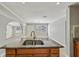 Close-up of a kitchen island with granite countertops, tile flooring, and stainless steel fixtures at 4101 W Leila Ave, Tampa, FL 33616