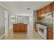 Traditional kitchen with stainless steel appliances, an island with granite countertop, and tile flooring at 4101 W Leila Ave, Tampa, FL 33616