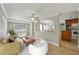 Bright living room featuring neutral colored furniture, tiled flooring, and views to the dining and kitchen areas at 4101 W Leila Ave, Tampa, FL 33616