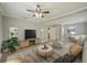 Cozy living room featuring neutral tones, ceiling fan, and minimalist decor with lots of natural light at 4101 W Leila Ave, Tampa, FL 33616