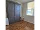 This bedroom features a murphy bed, a window for natural light, and laminate wood flooring at 4915 Bay Ne St # 322, St Petersburg, FL 33703