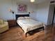 Comfortable bedroom with a queen bed, wall sconces, and neutral decor at 4915 Bay Ne St # 322, St Petersburg, FL 33703
