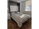 Spare bedroom featuring a murphy bed pulled out, maximizing space and functionality at 4915 Bay Ne St # 322, St Petersburg, FL 33703