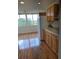 Bright kitchen boasts wood cabinets, granite counters, and a refrigerator at 4915 Bay Ne St # 322, St Petersburg, FL 33703