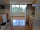 Updated kitchen with modern appliances, wood cabinets, and a view of a bright eating area at 4915 Bay Ne St # 322, St Petersburg, FL 33703